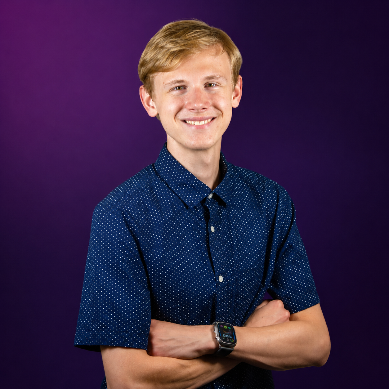 Founder of Severn Home Theater, arms crossed and smiling against a deep purple backdrop